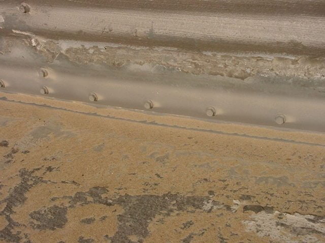 Sand blasting to prepare the base of the grain bin